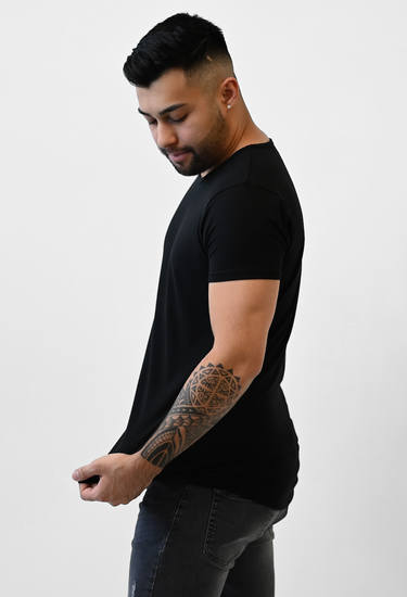 man posing in onyx black short sleeve drop cut t-shirt